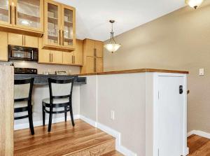 a kitchen with two chairs and a bar in a house at Crestview Place Mountain View Balcony & Shuttle in Winter Park