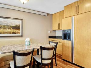 a kitchen with a table and chairs and a refrigerator at Crestview Place Mountain View Balcony & Shuttle in Winter Park +23 photos