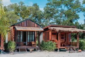 a wooden house with a thatched roof at Laleuca At Laemhad Kohyaoyai in Ko Yao Yai