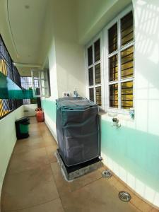 a bathroom with a trash can in the corner of a building at Athreyas@60/A in Mysore