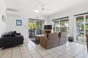 a living room with two chairs and a couch at Villa 31 Tangalooma Beach Front in Tangalooma