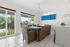 a dining room with a table and chairs at Villa 31 Tangalooma Beach Front in Tangalooma