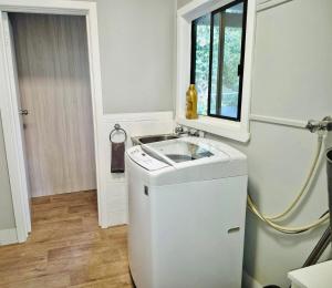 a small kitchen with a sink and a window at Wombat Cottage Albury in Albury +17 photos