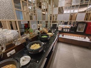 a buffet line in a restaurant with bowls of food at Region Motel in Lukang