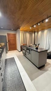 a kitchen with a large island in the middle at Altos do Perito Cabanas in Alfredo Wagner