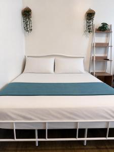 a bed in a room with a white mattress at Antara Residential Condominium in Talisay +19 photos