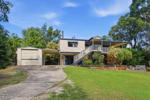 a house with a garage and a driveway at Quandamooka Beach House in Bulwer