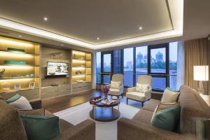 a living room with a couch and a table at Ascott Heng Shan Shanghai in Shanghai