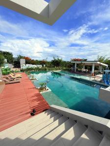 a large swimming pool with a wooden deck at Antara Residential Condominium in Talisay
