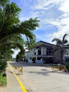 a building with palm trees in front of a street at Antara Residential Condominium in Talisay