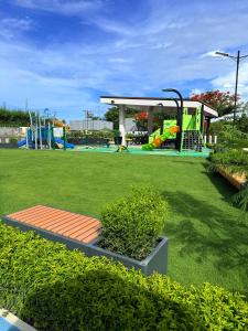 a park with a playground with a playground at Antara Residential Condominium in Talisay