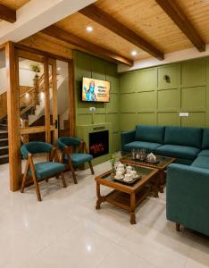 a living room with blue couches and a fireplace at The Alpine Escape, Manali - A Beautiful Cottage in Cloud's in Manāli +24 photos
