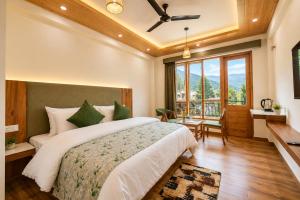 a bedroom with a large bed and a large window at The Alpine Escape, Manali - A Beautiful Cottage in Cloud's in Manāli