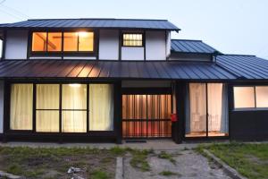 a house with a black roof and windows at 大宇陀souw創 in Uda