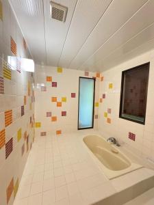 a large bathroom with a tub and a window at Hotel JOYCE in Saijō-chō +64 photos