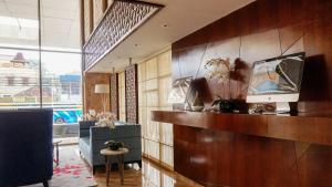 a lobby with a desk and a computer on a wall at Louis Kienne Hotel Pandanaran in Semarang