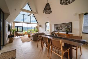 a living room with a large table and chairs at Buyan Lakeside Villas in Bedugul
