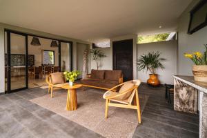 a living room with a couch and chairs and a table at Buyan Lakeside Villas in Bedugul