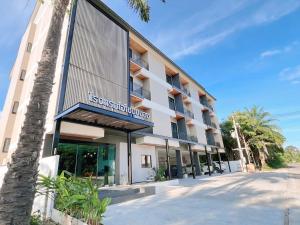 a building with a sign on the side of it at Ozone hotel khanom in Ban Phang Phrao