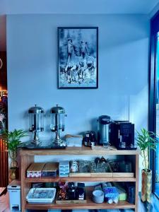 a shelf with a picture on a blue wall at Ozone hotel khanom in Ban Phang Phrao