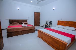a bedroom with two beds in a room at LHK Dream Resort Matara in Palatuwa