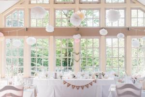 a wedding reception with white paper clouds hanging from the ceiling at Hotel Farchauer Mühle in Ratzeburg