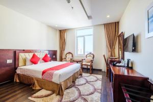 a hotel room with a bed and a desk at GIC Land Hotel in Danang +46 photos