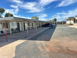 an empty parking lot in front of a motel at Charles Sturt Motor Inn in West Wyalong