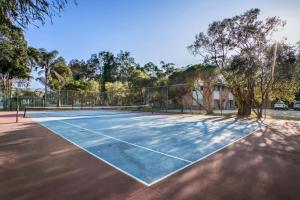 a tennis court with a net on it at Tasman Holiday Parks - Kioloa Beach in Kioloa