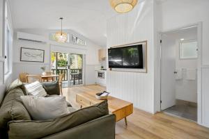 a living room with a couch and a table at Tasman Holiday Parks - Kioloa Beach in Kioloa +25 photos