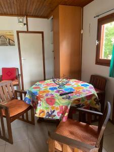 a table with a colorful table cloth on it in a room at La Palmeraie in Le Moule