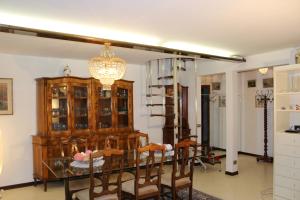 a dining room with a glass table and a chandelier at Corte Emo in Venice