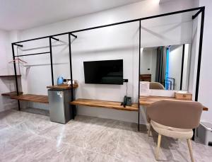 a room with a table and a television in a room at Ozone hotel khanom in Ban Phang Phrao