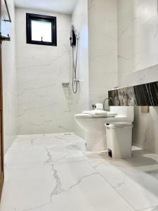 a white bathroom with a toilet and a shower at Ozone hotel khanom in Ban Phang Phrao +29 photos