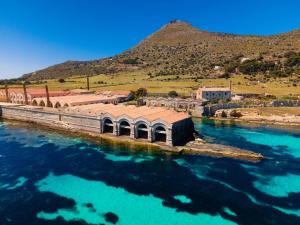 a building in the middle of a body of water at Almarè Affittacamere in Favignana