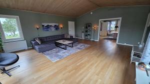 a living room with a couch and a table at Prestelandet Guesthouse in Fredrikstad