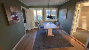 a dining room with a wooden table and chairs at Prestelandet Guesthouse in Fredrikstad
