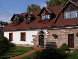 a white house with a brown roof at Apartmány Mladé Buky in Mladé Buky
