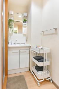 a bathroom with a white sink and a mirror at Haniwa Stay Josai in Nagoya +13 photos