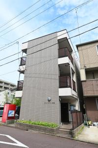 a building on a street next to a road at Haniwa Stay Josai in Nagoya
