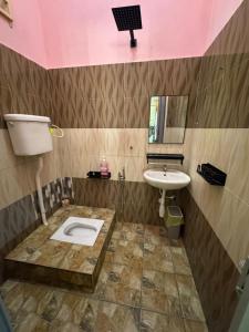 a bathroom with a toilet and a sink at SYA Homestay Bachok in Bachok
