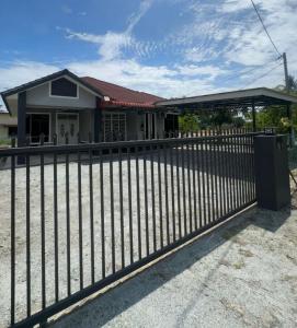 a black fence in front of a house at SYA Homestay Bachok in Bachok