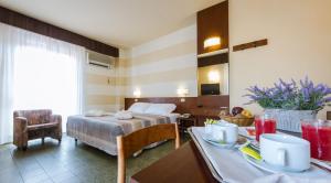 Habitación de hotel con cama y mesa de comedor en Hotel Reale, en Montecatini Terme