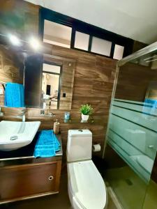 a bathroom with a toilet and a sink and a mirror at Depa YAZI in Villahermosa +15 photos