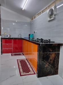 a kitchen with a stove and a counter top at SELAMA Merdeka Homestay 2-6pax in Selama