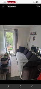 a living room with a couch and a window at Andrea house in Thornton Heath +3 photos