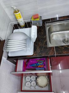 a kitchen with a sink and some dishes in a drawer at SELAMA Merdeka Homestay 2-6pax in Selama