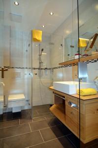 a bathroom with a sink and a shower at Hotel Sonnalp in Kirchberg in Tirol