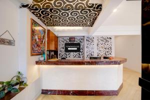 a bar with a gold and white patterned ceiling at Townhouse Gandhi Medical College Bhopal Formerly Hotel Shagun in Bhopal