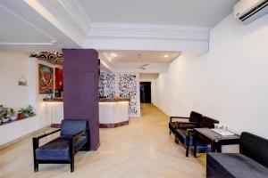 a lobby with chairs and a table and a bar at Townhouse Gandhi Medical College Bhopal Formerly Hotel Shagun in Bhopal